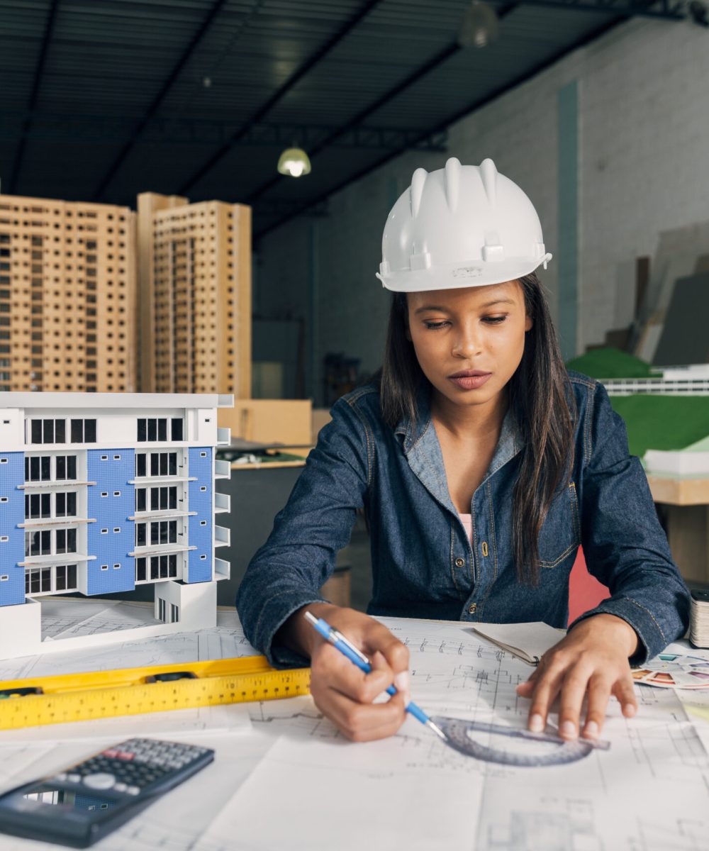 african-american-lady-safety-helmet-working-near-model-building